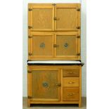 An early 20th c Hygena kitchen cupboard, with sliding enamelled work surface, the fitted interior