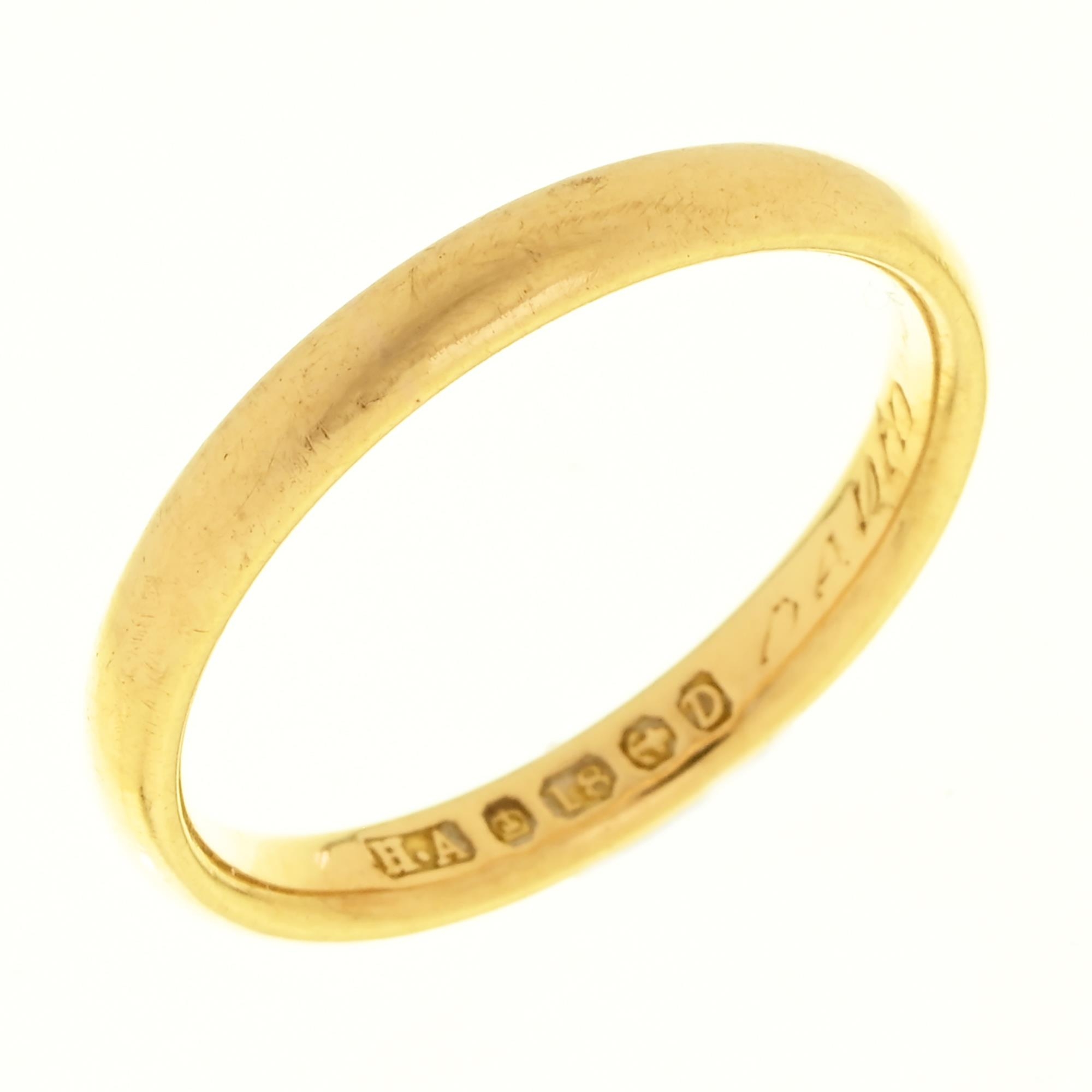 A 22ct gold wedding ring, Birmingham 1989, 11.2g, size K½ Wear consistent with age