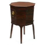 A George III mahogany octagonal wine cooler, with zinc liner, brass lion mask handles, on square