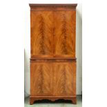 A flame figured mahogany cocktail cabinet, with dentil cornice, 154cm h; 41 x 71cm Good condition