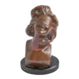 An electro-formed and bronze patinated sculpture of the head of a smiling young woman in a