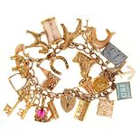 A gold charm bracelet, with gold padlock and a collection of gold charms, approximately 17cm l, 56.