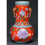 A Chinese coral red ground vase, 20th c,  the cylindrical neck with elephant head handles and