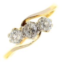 A three stone diamond ring, with old cut diamonds, in gold marked 18ct, 2.6g, size M Wear consistent