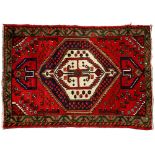 An antique rug, 106 x 130cm and another, 130 x 180cm (2) Typical wear, the smaller rug with loss