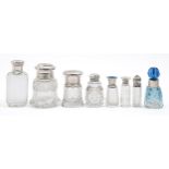 Eight Victorian and early 20th c silver capped or mounted cut or faceted glass scent bottles,