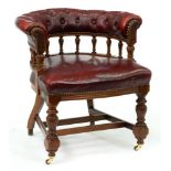 A Victorian walnut chair, in close nailed buttoned red leather with galleried arm bow and carved