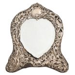 An Edwardian silver heart shaped dressing mirror, with die stamped rococo mount, 30cm h, maker's