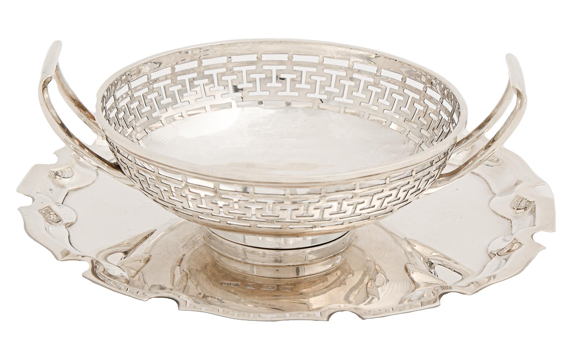 A George V two handled pierced silver bonbon dish, 10.5cm diam, by Harrodd Stores Ltd, London 1912