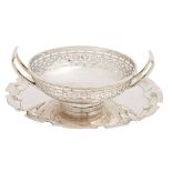 A George V two handled pierced silver bonbon dish, 10.5cm diam, by Harrodd Stores Ltd, London 1912