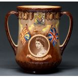 A Royal Doulton commemorative earthenware loving cup, decorated to either side with sepia