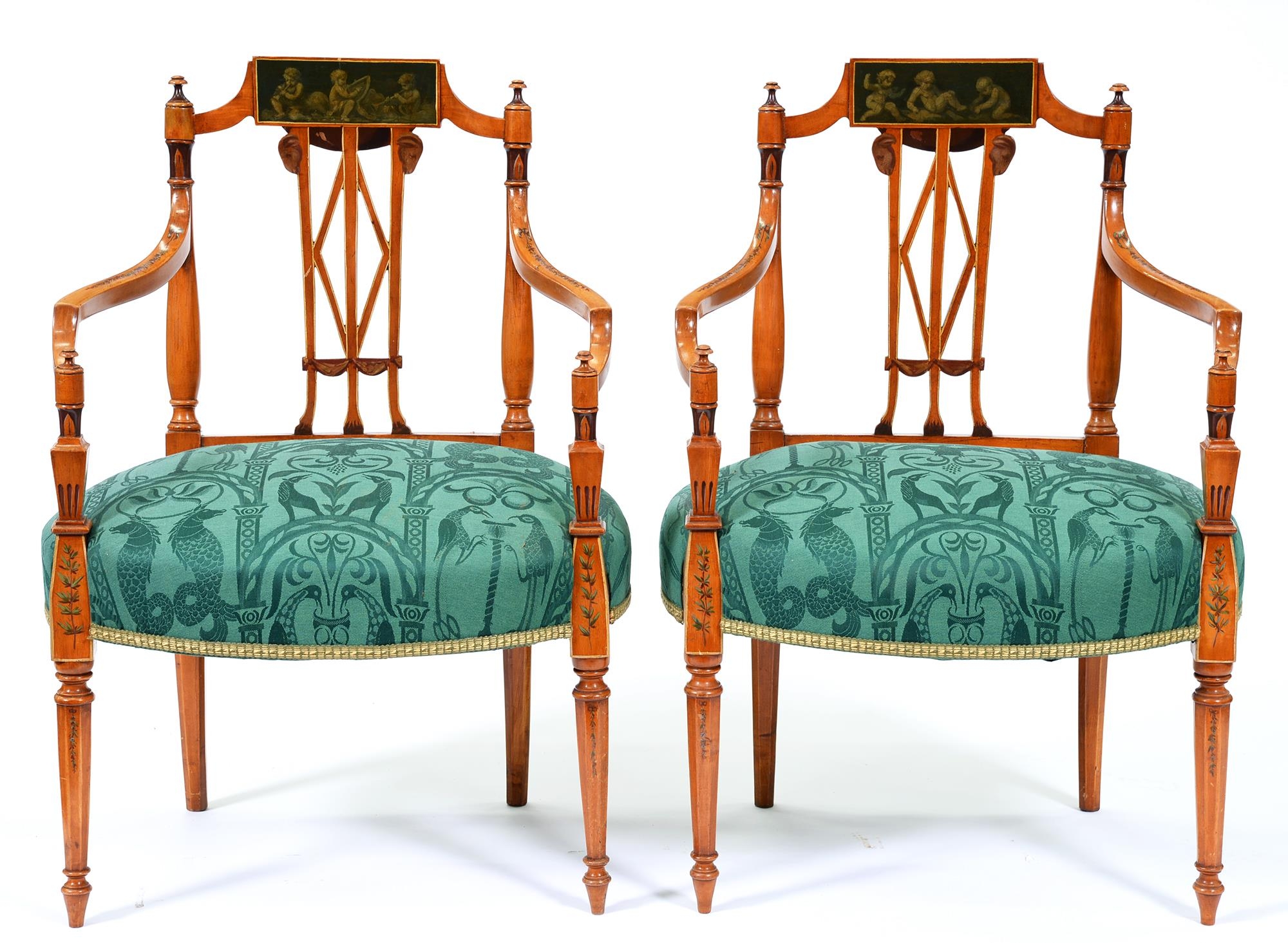 A pair of painted satinwood elbow chairs, early 20th c, in George III style, the  back with