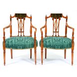 A pair of painted satinwood elbow chairs, early 20th c, in George III style, the  back with