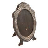 An Edwardian Art Nouveau silver mirror or photograph frame, the die stamped mount with insects and