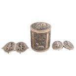 Two South East Asian silver repousse waist clasps and a Burmese cylindrical silver repousse canister