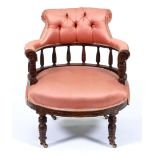 An Edwardian stained oak salon chair, with buttoned rail to the galleried back, on turned legs, seat