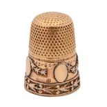 A gold thimble, c1900, the skirt applied with festoons and medallions, 21mm h, marked 18, 5.6g