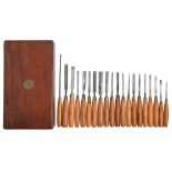 Twenty chisels and carving gouges, with boxwood handle, in a 19th c mahogany box, 21 x 38cm