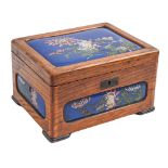 A Japanese silk lined wood jewel box, inset with blue ground cloisonne enamel panels, second quarter