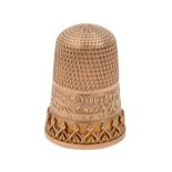 A 9ct gold thimble, the skirt with applied decoration and engraved RUTH, 22mm h, maker's mark
