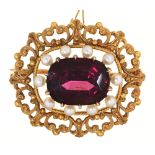 A cushion shaped garnet and seed pearl brooch, 19th c, in gold, 28mm l, 6.9g The garnet of
