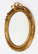 A Victorian giltwood oval bevelled mirror,