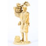 A Japanese ivory okimono, Meiji period, of a man holding a basket of vegetables