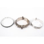 A collection of three Omani style white metal bangle bracelets, 133g.