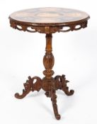 A 19th century Austrian Black Forest carved centre table with penwork decorated top,