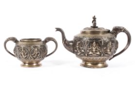 An early 20th century Indian white metal teapot with matching sugar bowl,