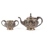 An early 20th century Indian white metal teapot with matching sugar bowl,