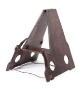 A Victorian stained oak folding book stand, of triangular form, with pierced circular ornament,