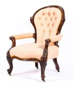 A Victorian mahogany framed button back upholstered armchair,