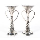A pair of Edwardian silver spill vases, adorned with two flowing vines in the Art Nouveau style,