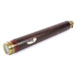 A late 19th century brass single drawer telescope, the outer case bound in leather,