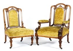 A pair of Victorian walnut framed upholstered armchairs,