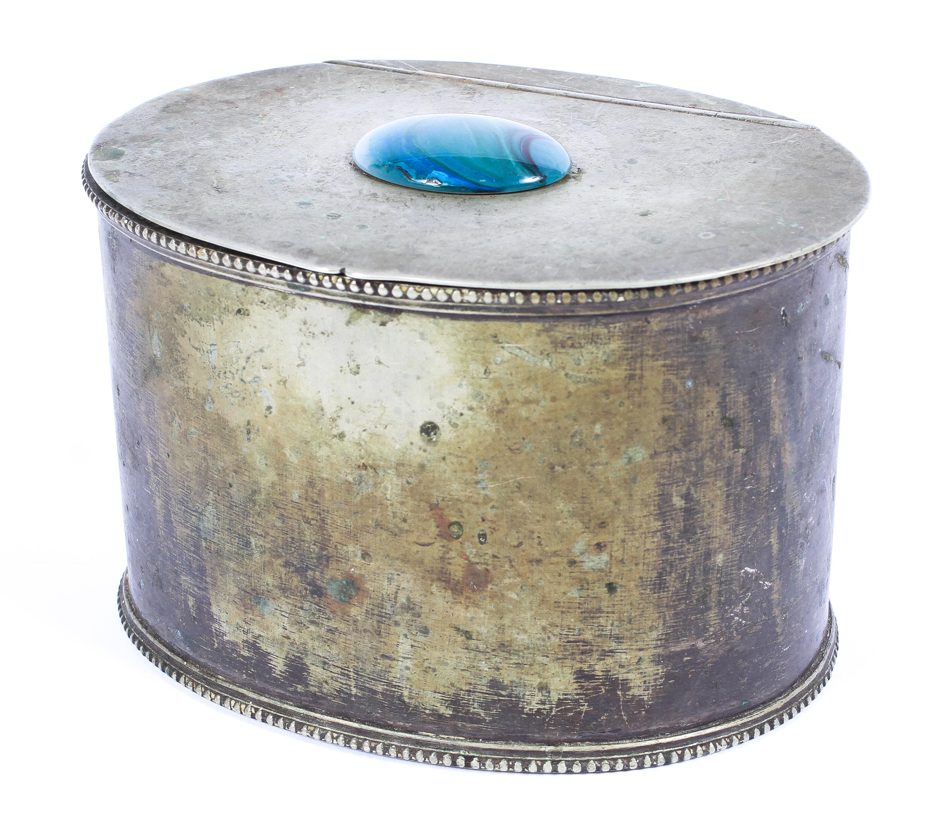 A white metal Arts and Crafts style oval tea caddy,