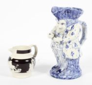 A Victorian stoneware jug and a pottery toby jug,