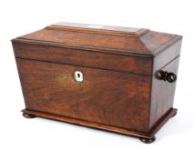 A Regency rosewood tea caddy, of sarcophagus form with mother of pearl escutcheon,