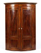 A 19th century veneered bow fronted corner cabinet,