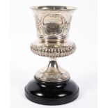 A William IV silver trophy of urn form, with repousse decorated floral sprays, over gadroons,