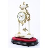 A French gilt-metal and white marble mounted pedestal striking mantle clock on ebonised base,