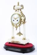 A French gilt-metal and white marble mounted pedestal striking mantle clock on ebonised base,