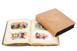 Two Victorian/Edwardian postcard albums containing a large collection of postcards,