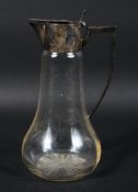 An early 20th century silver mounted glass claret jug, the base with star cut decoration,
