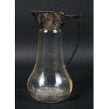 An early 20th century silver mounted glass claret jug, the base with star cut decoration,