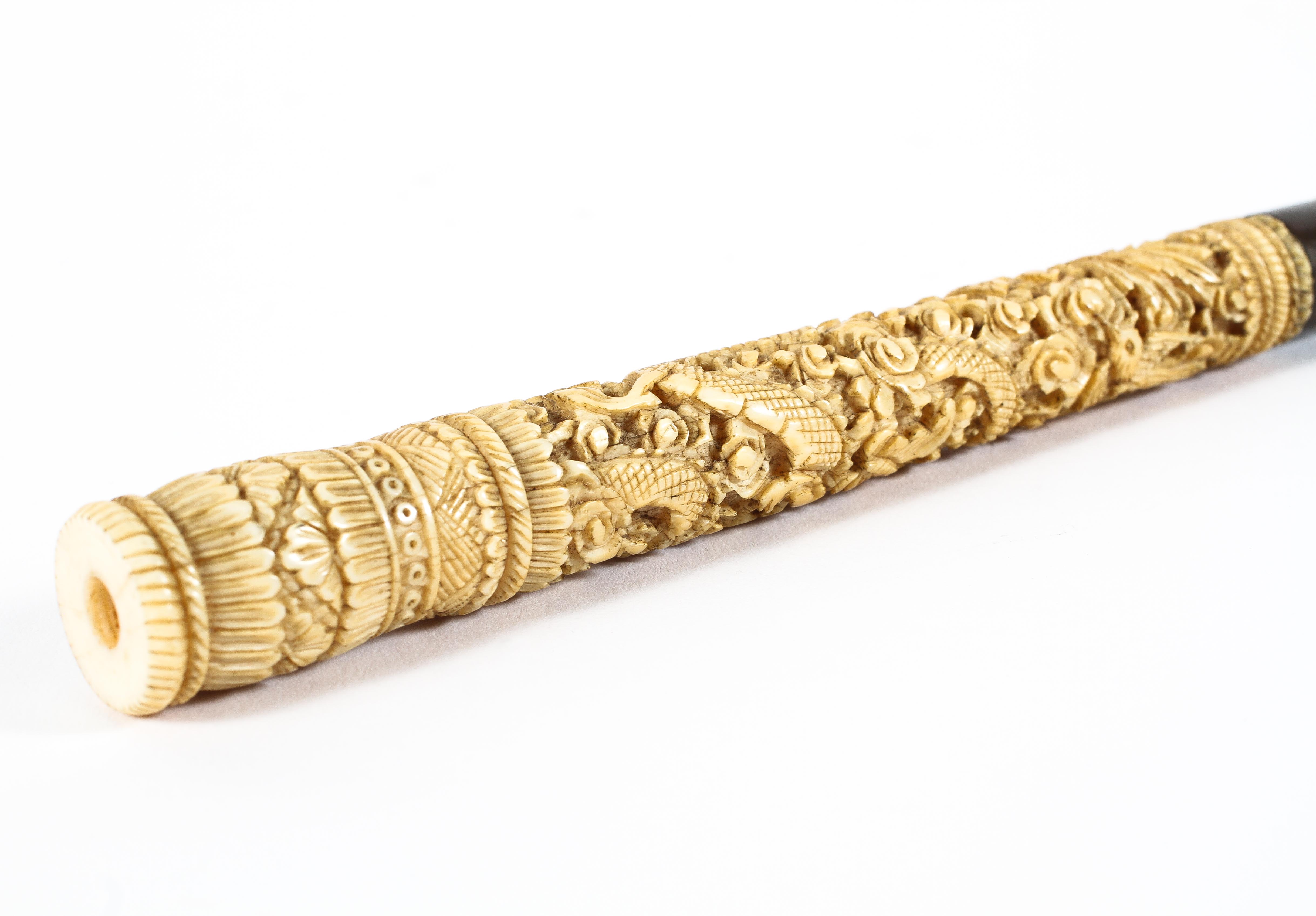 A Chinese carved ivory parasol handle in two parts, late 19th century, - Image 2 of 2