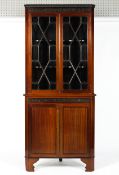 A Georgian mahogany corner cupboard, the double glazed doors enclosing two scroll edged shelves,