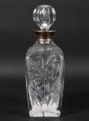 A mid century silver mounted glass decanter, the cut glass body decorated with floral sprays,