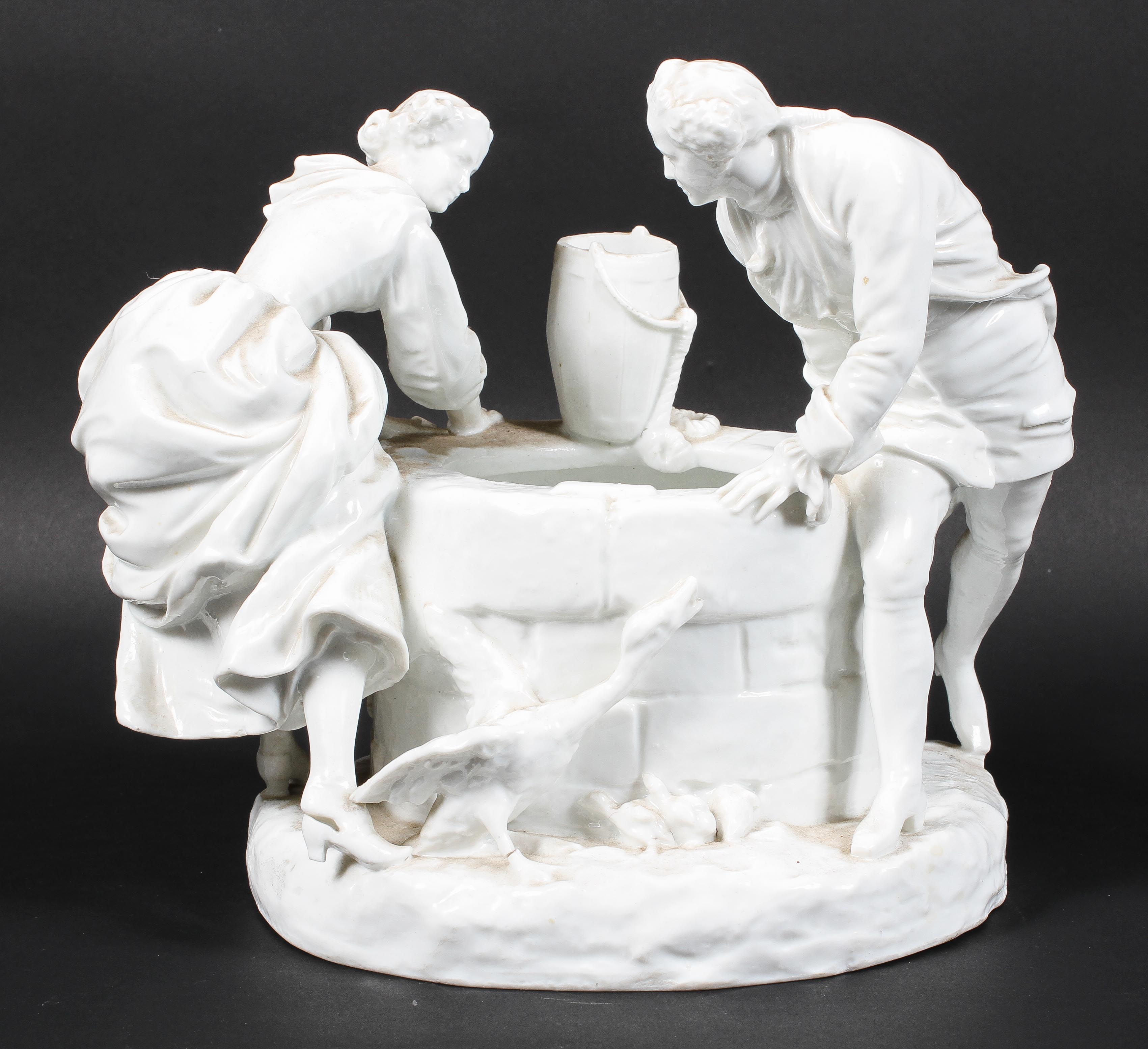 A Continental porcelain figure group beside a well, late 19th century,